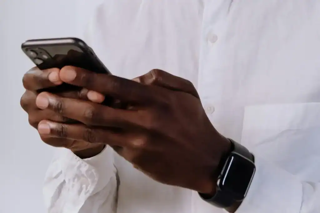 womans hands, typing on a phone