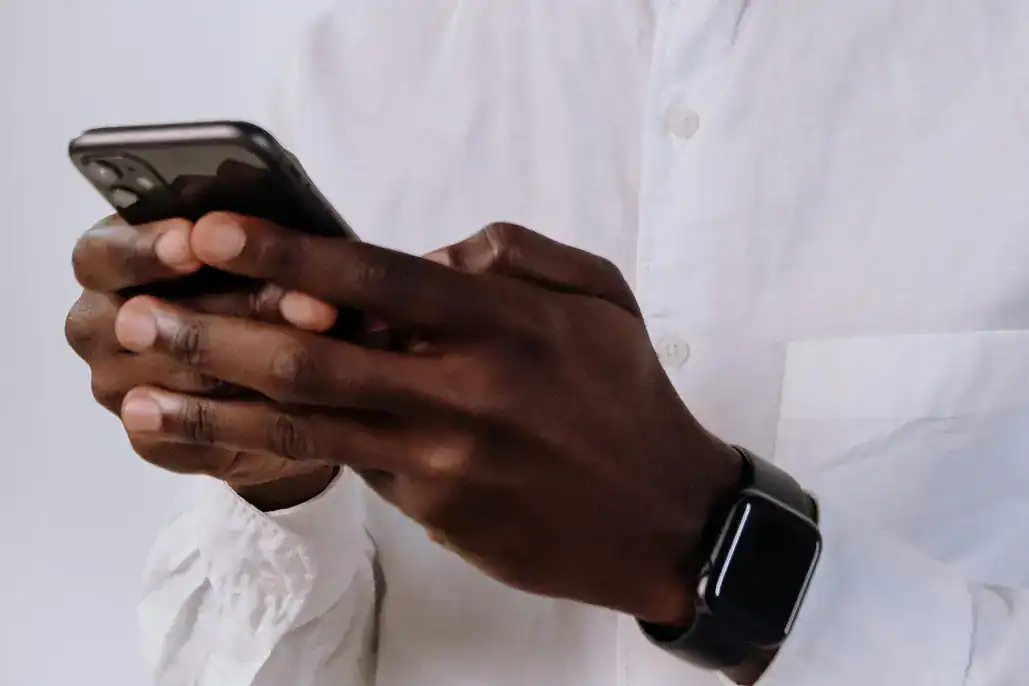 womans hands, typing on a phone