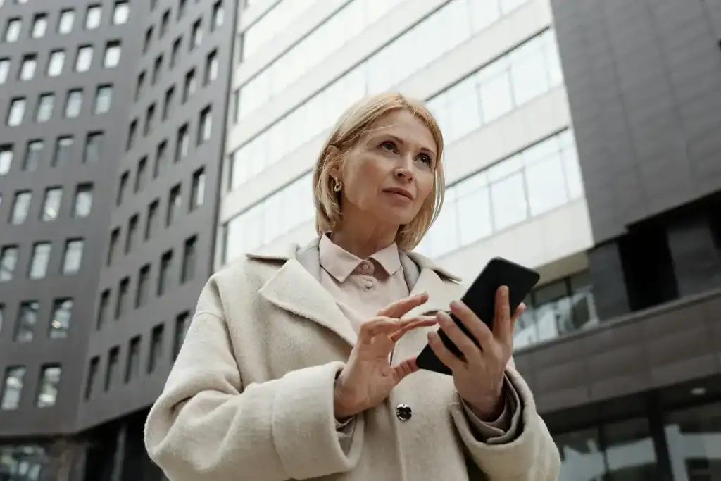 Woman walking in the street busy on her phone