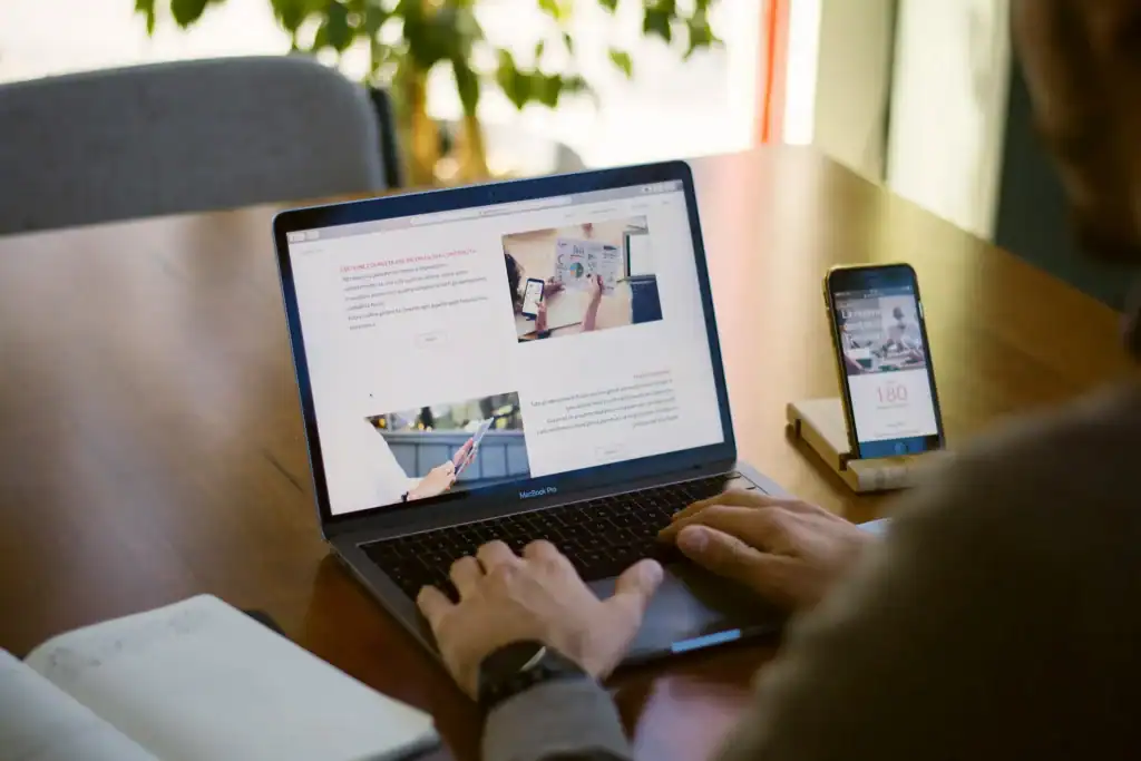 Man working on a laptop and phone