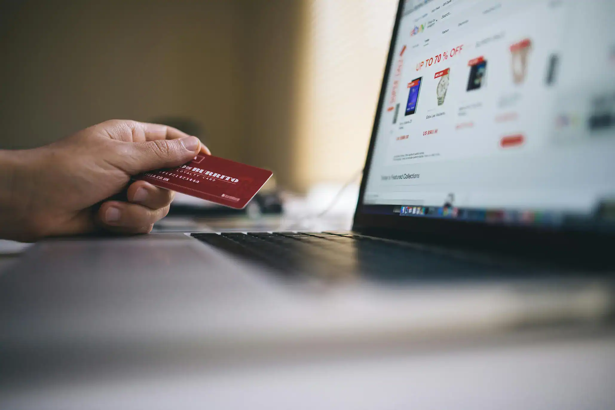 Person shopping online with credit card | Is Your Ecommerce Web Design Killing Your Conversion Rate?