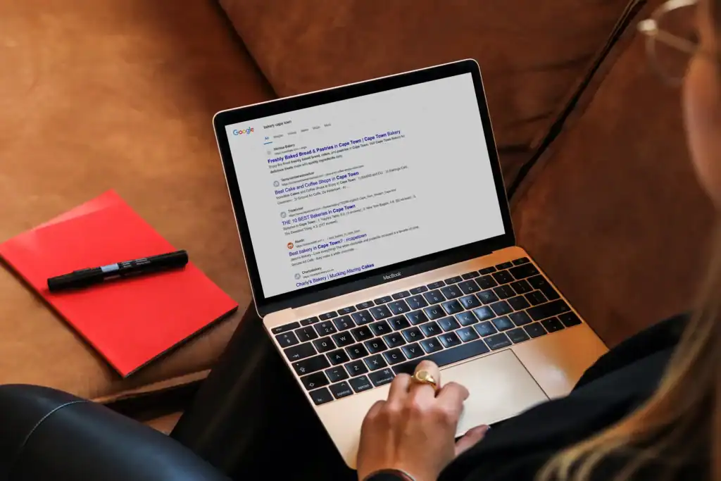 Person using laptop on a sofa | Local SEO Cape Town: Boost Your Business Visibility